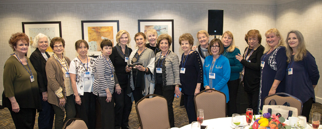 A large group of women, posing in a long row